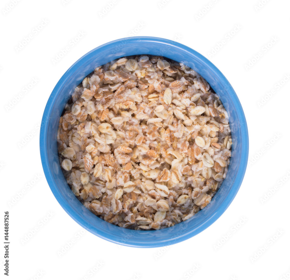 Oatmeal in a blue cup on a white background
