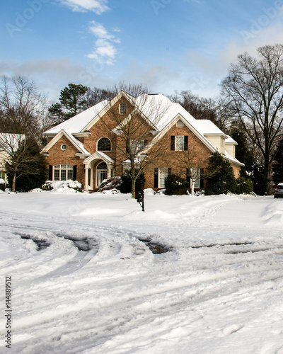 Beautiful estate home with snow covered roads © clsdesign
