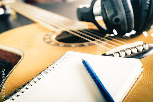 Guitar and Headphone with blank notebook for songwriting