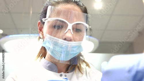 Female stomatologist in mask. Woman doctor working. How to become a dentist.