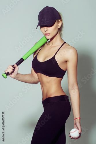 Canvas Print Pretty sporty girl athlete player holding green baseball bat, ball