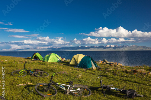 Camping for cyclists on the shore of the beautiful mountain lake Son Kul. Kyrgyzstan.