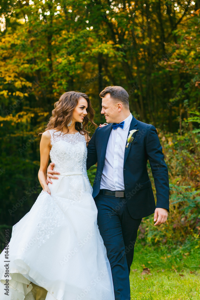 Elegant curly bride and stylish groom