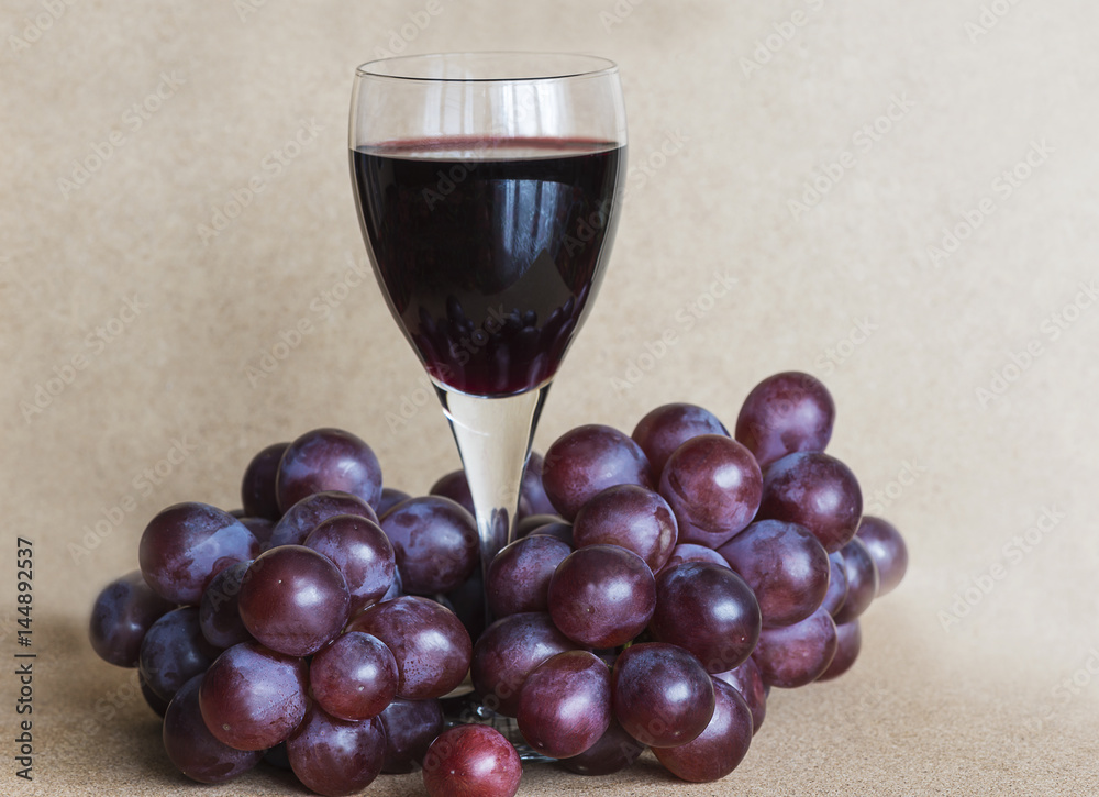 glass of red wine and grapes glass of red wine and grapes