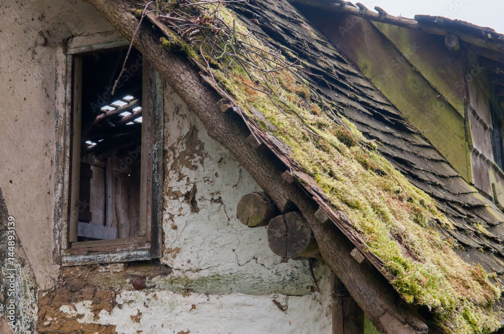 Run down building with broken roof and growing moss Run down building with broken roof and growing moss
