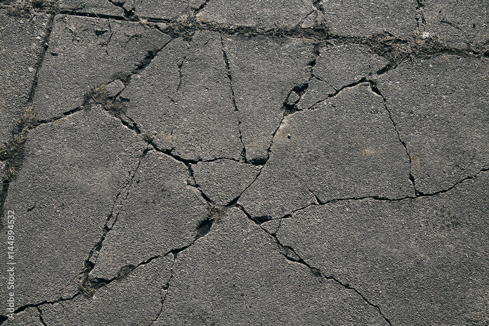 Obraz premium Asphalt with cracks. cracked asphalt road surface texture. 