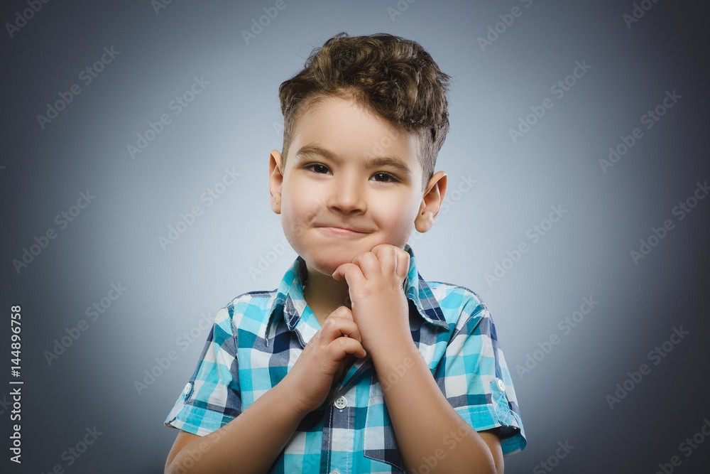doubt, expression and people concept - boy thinking over gray background doubt, expression and people concept - boy thinking over gray background