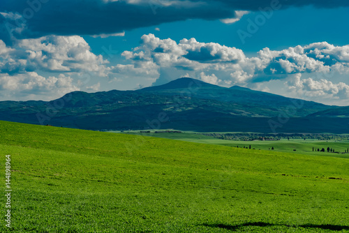 Panorama of green val d'orcia hills in tuscany italy in spring, land of red wine and cypresses
