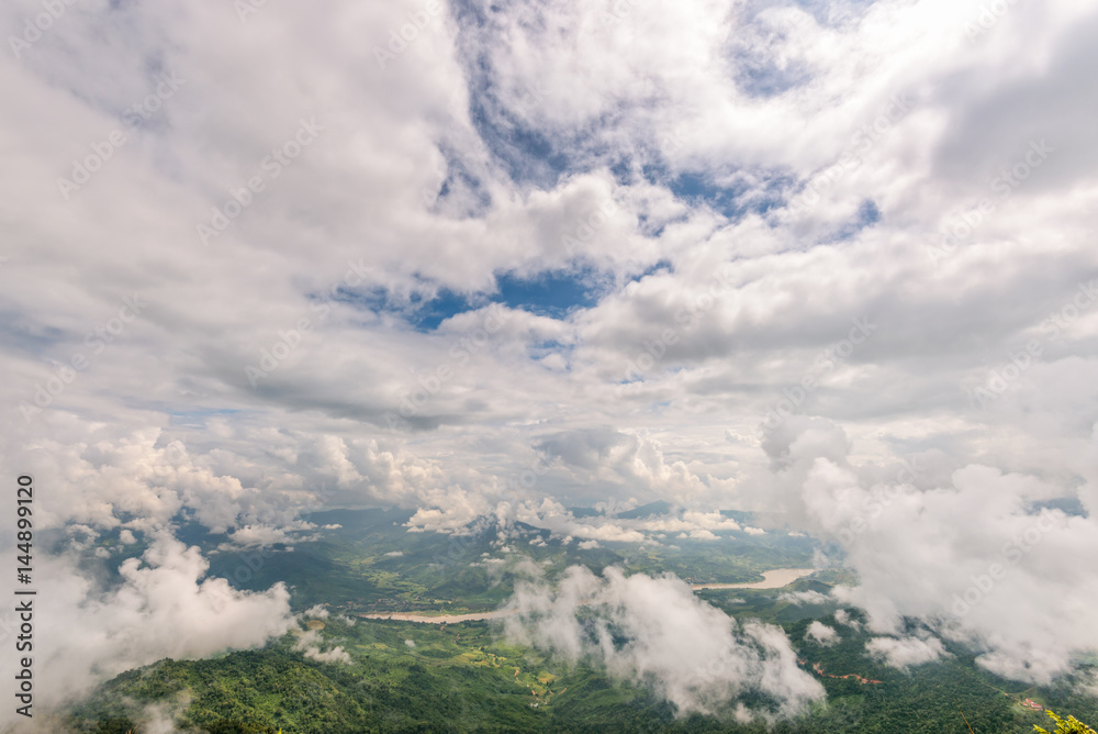 Beautiful natural landscape from high angle view of Mekong River forest and white clouds in the sky on the mountain at Doi Pha Tang view point, Chiang Rai Province, Thailand