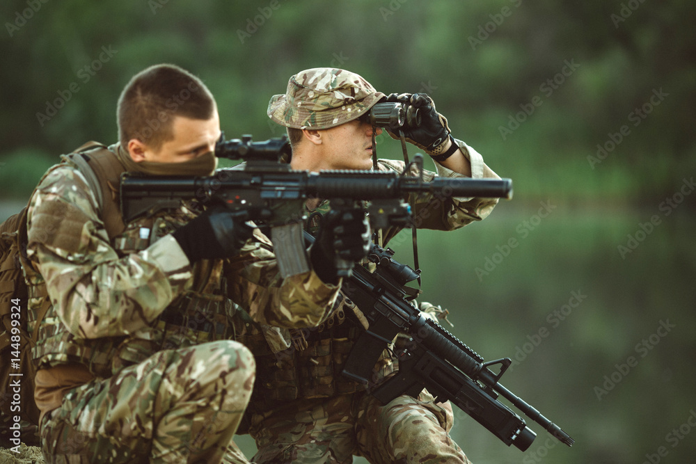 Special forces soldiers with weapon take part in military maneuver. war, army, technology and people concept. Special forces soldiers with weapon take part in military maneuver. war, army, technology and people concept.