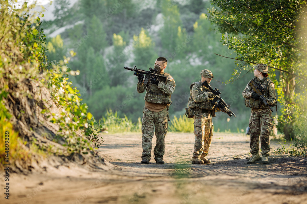 Special forces soldiers with weapon take part in military maneuver. war, army, technology and people concept.