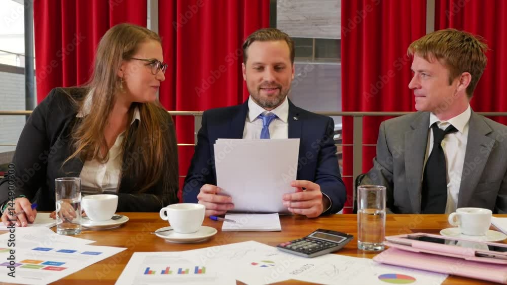 Business team discussing positive results in a meeting. Business team discussing positive results in a meeting.