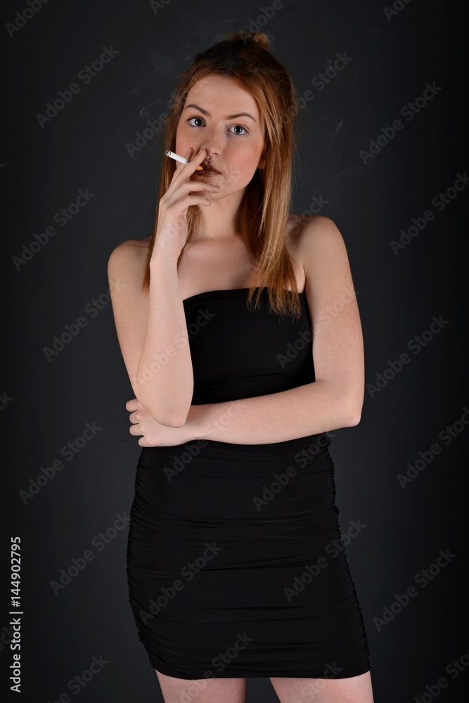 young woman with cigarette, smoking concept on black background young woman with cigarette, smoking concept on black background