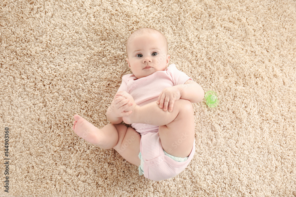 Portrait of adorable baby on light carpet background Portrait of adorable baby on light carpet background