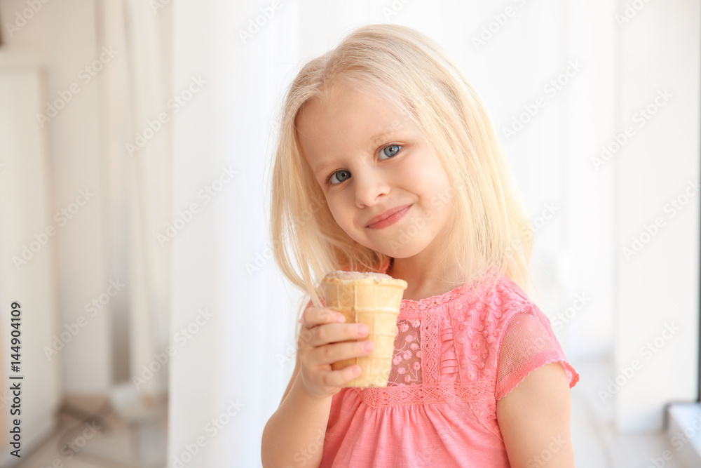 Cute little girl eating ice cream at home Cute little girl eating ice cream at home