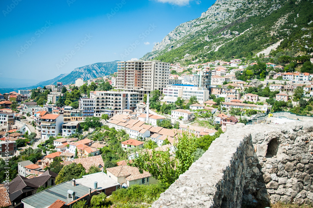 2016, Albania, Kruja. Beautiful view to the city and moutains. Blue sky and green landscape with red roofs of the city