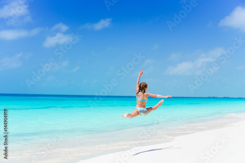 Active little girl at beach having a lot of fun on the shore © travnikovstudio