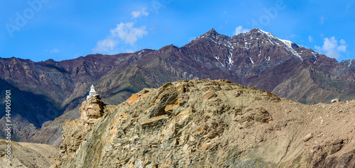 Unique ancient Buddhist stupa built stupa on the road near Basgo monastery - Tibet, Leh district, Western Ladakh, Himalayas, Jammu and Kashmir, Northern India photo