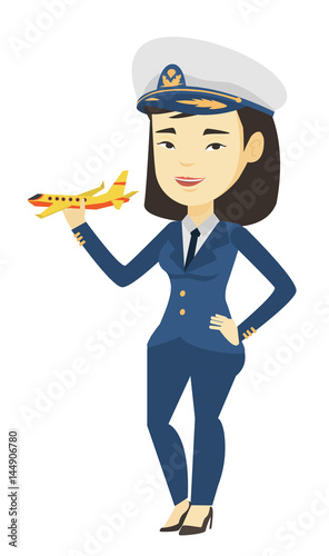 Cheerful airline pilot with model airplane.