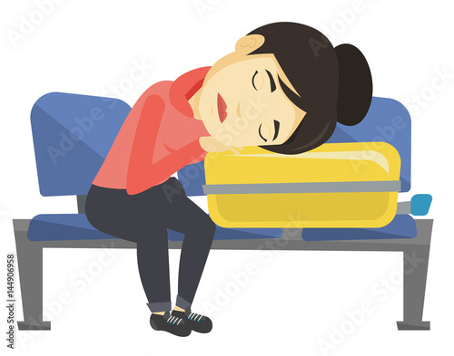 Exhausted woman sleeping on suitcase at airport.