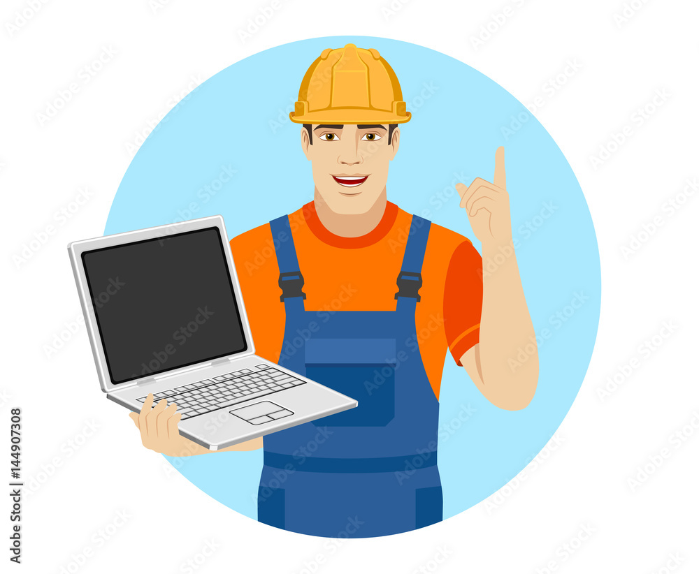 Builder holding laptop notebook and pointing up