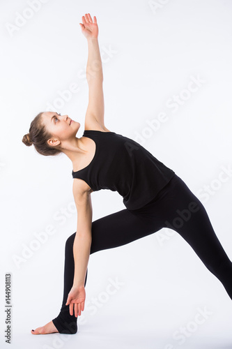 Young yoga woman warrior pose. This is part of a series of various yoga poses by this model, isolated on white