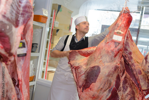 Photos Butcher with animal carcass