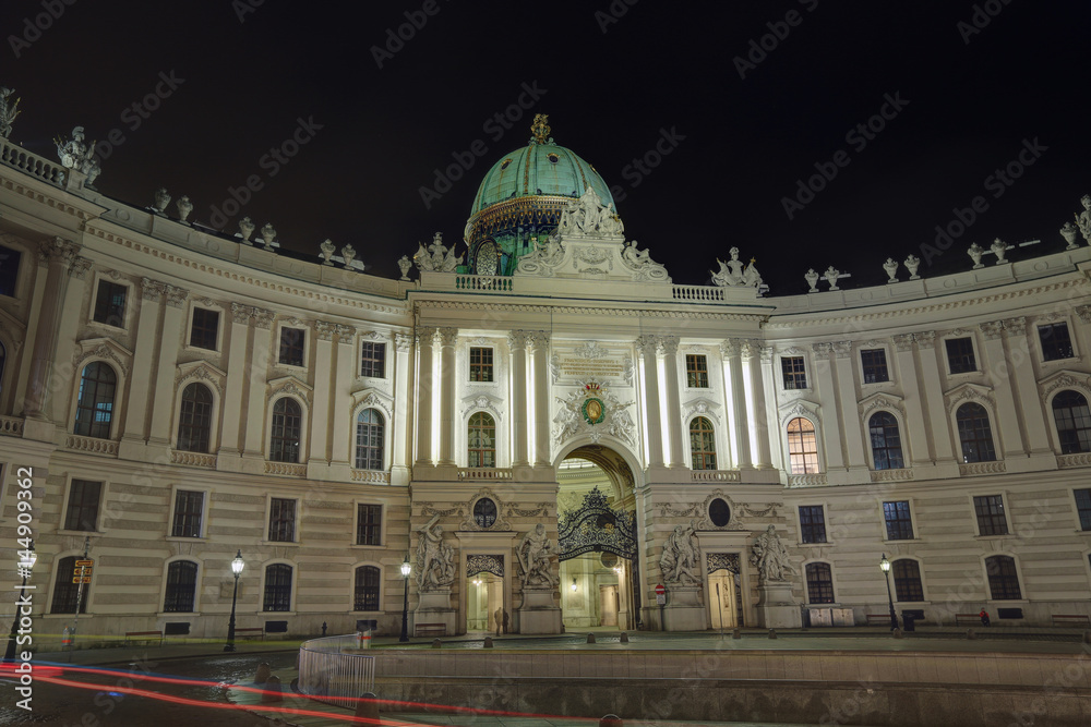Building of the St. Michael wing (Michaelertrakt) of the Hofburg Palace with night illumination. Vienna, Austria