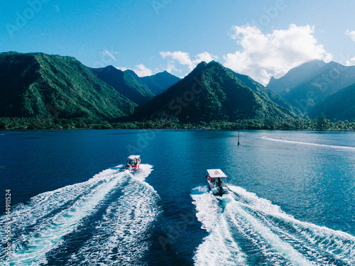 Aerial view of boats on water, heading towards island, Teahupoo, Tahiti, South Pacific photo