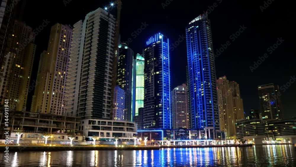 4K Dubai Marina night time lapse, United Arab Emirates. Dubai Marina - the largest man-made marina in the world. Dubai Marina is a canal city, carved along a 3 km stretch of Persian Gulf shoreline 4K Dubai Marina night time lapse, United Arab Emirates. Dubai Marina - the largest man-made marina in the world. Dubai Marina is a canal city, carved along a 3 km stretch of Persian Gulf shoreline