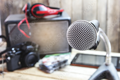Analog microphone on a wooden table. © jojokrap