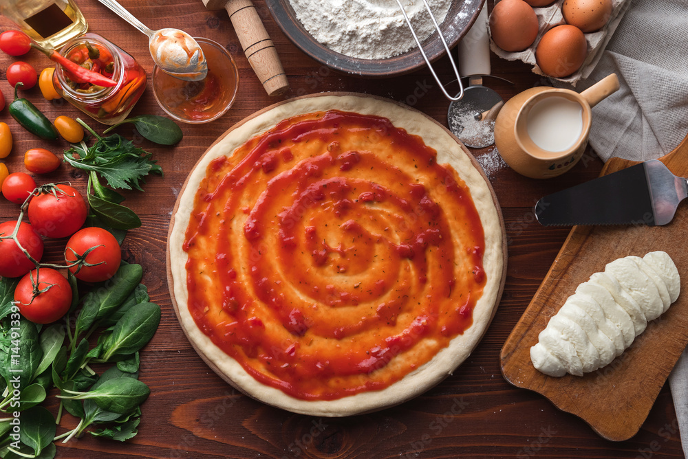 Step-by-step boss makes a pizza margarita. Dough and pizza ingredients