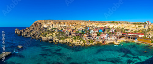 Fototapeta Naklejka Na Ścianę i Meble -  Il-Mellieha, Malta - Panoramic skyline view of the beautiful Popeye Village at Anchor Bay. This village was the set in Robert Altman's famous movie 'Popeye' with Robin Williams in the main role.
