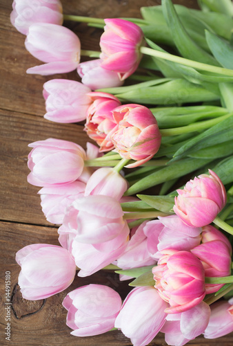 Pink tulips on the wooden background. Pink tulip. Tulips. Flowers. Flower background. Flowers photo concept. Colored tulips. Petals..Holidays photo concept. Copyspace. Peony Tulip