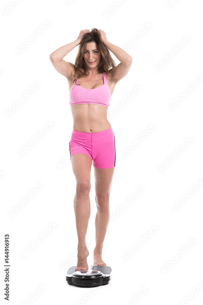 Young woman near scale unhappy with her weight gesturing sadness. Fit and healthy concept. Isolated over white background