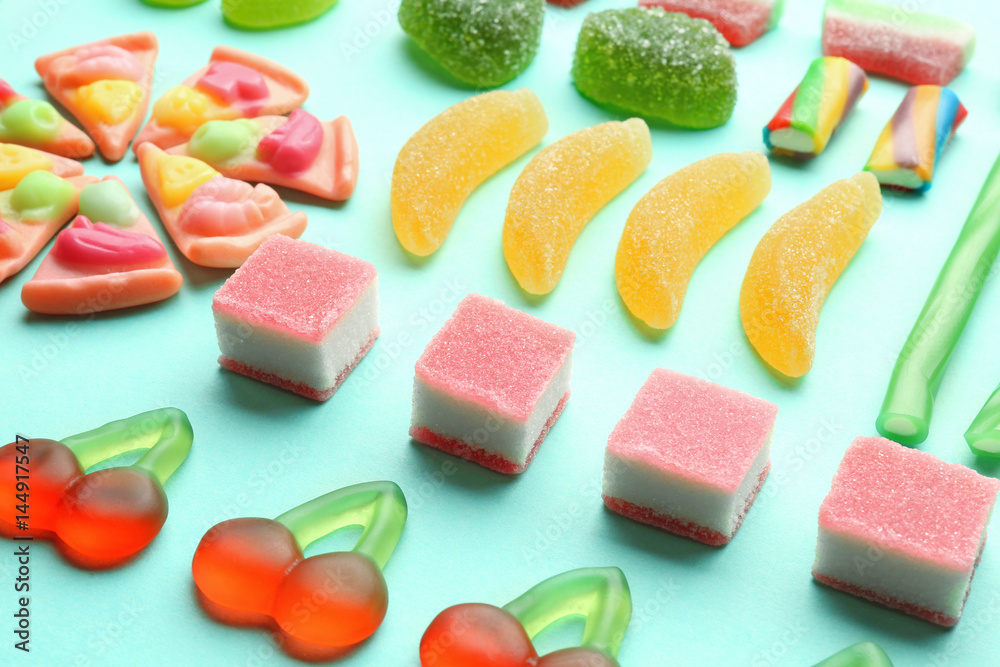 Composition of tasty jelly candies on color background, closeup Composition of tasty jelly candies on color background, closeup