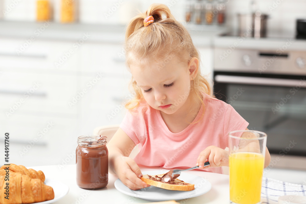 Cute little girl having breakfast at home Cute little girl having breakfast at home