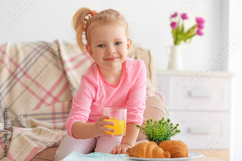 Cute little girl having bre...