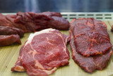 Pieces of fresh raw  meat in a butcher window display