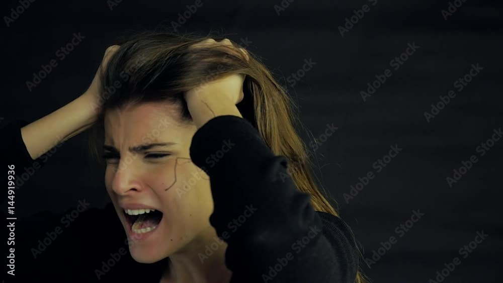 Young woman screaming and crying desperate closeup slow motion