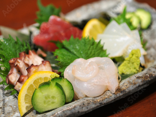 Fresh sashimi of fugu fish with cucumber, lemon and wasabi