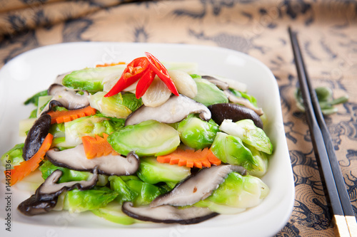 Sauteed squid with cabbage and carrot on white platter