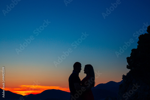 Silhouettes at sunset on the beach in Montenegro © Nadtochiy