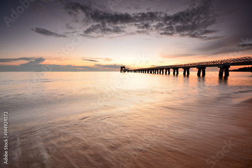 Long exposure shot of seascape with long jetty background.