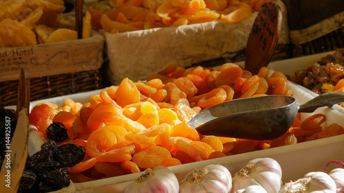 Dried apricot fruit on heap at marketplace. Close up.