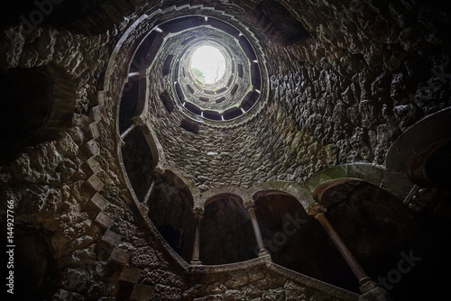 The Initiation well of Quinta da Regaleira in Sintra. The depth of the well is 27 meters. It connects with other tunnels through underground passages. Sintra. Portugal