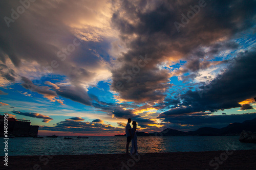 Silhouettes of couples near Sveti Stefan island in Montenegro