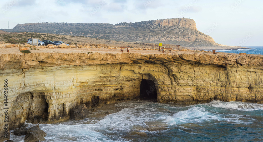 Panorama of sea caves on Mediterranean Sea coast at sunset. Cape Greko, Cyprus. 

