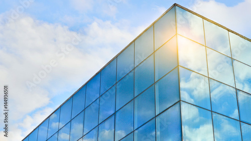 Blue sky with white clouds reflected in the windows. Abstract background for business purposes.