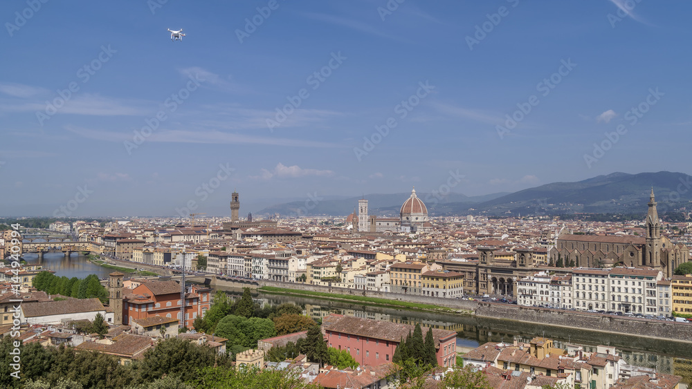 Magnificent panoramic aerial view of the historic center of Florence, Tuscany, Italy, from Piazzale Michelangelo, on a sunny day and a drone flying in the blue sky Magnificent panoramic aerial view of the historic center of Florence, Tuscany, Italy, from Piazzale Michelangelo, on a sunny day and a drone flying in the blue sky